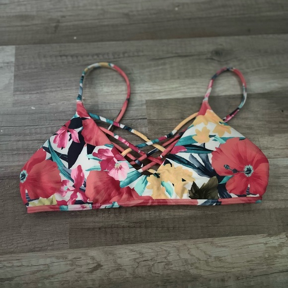 Bikinis top with floral designs and crisscross on the front. Comes with padding. - Picture 1 of 3